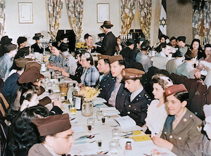 There was a Jewish synagogue in Vincennes, Indiana from 1935 until 1965. The synagogue, 'shul' in Yiddish, was known as Hovas Hochim, and founded by Louis Dumes, William Dumes (my grandfather), Ben Karp, and a few others. <br><br>The cornerstone on the building was dedicated to my great-grandmother as 'Mother Dumes'. My Dad saved the cornerstone when the building was pulled down. But that's another story. <br><br>This photo is from April 8, 1944 when Jewish soldiers stationed at local George Field were invited to celebrate the Passover seder at the shul. Louis Dumes is standing with his back to us in the center. 